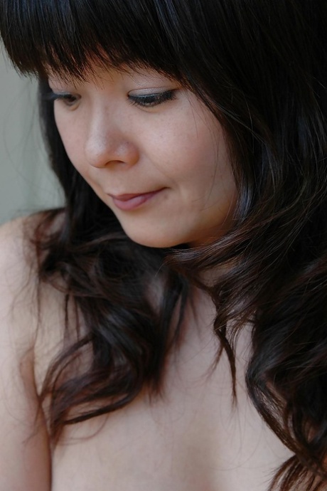 Asian woman named MILF Miyuki Miyaji is seen naked and engaging in self-pleasure.