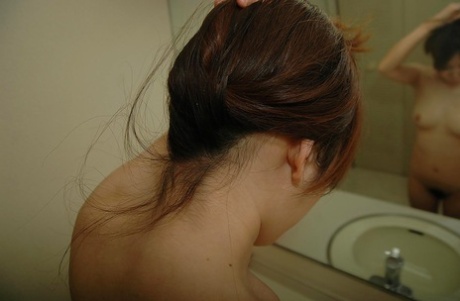 Tomoe Nitta, a beautiful Asian girl enjoying herself in the shower.