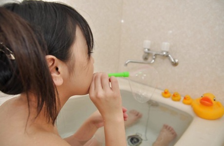 Playful asian teenage cutie Syoko Narita has some fun in the bath