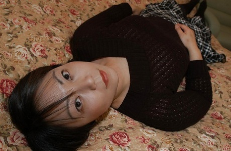 In her love holes, Rumi Yasumoto, a Chubby Asian MILF, is undressing and playing with clothes.