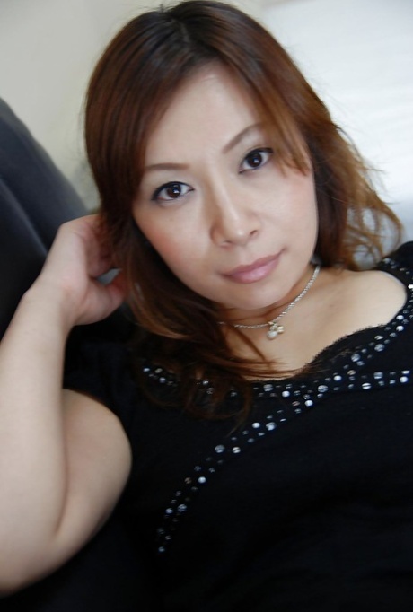Asian MILF Machiko Nishizaki undresses and exposes her pleasurable cunt.