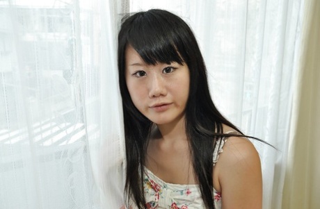 Asian teen takes off her panties and gets her shaved vag pleased with toys