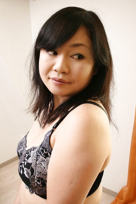 Rumiko Shiga, a curvy Asian MILF member, is stripping down to her clothes.