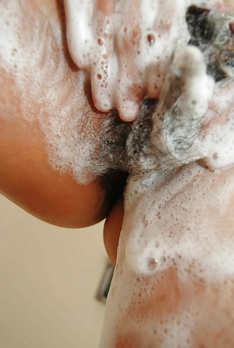 After a shower, Natsuko Miyamoto showcased her Asian beauty by playing with the hair in a messy ponytail.