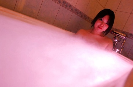 The unappealing Fumika Murase is a petite Asian female who looks disgusting in her bath.