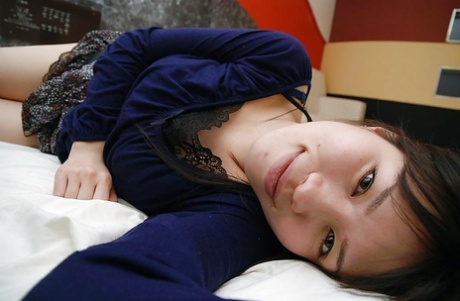 Asian hen Yumi Wakabayashi undresses and enjoys her hairy cunty close up.