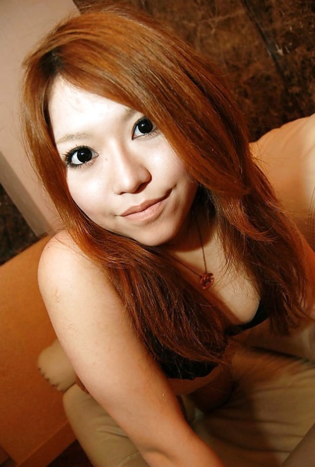 An Asian girl named Chiaki Eguchi is seen undressing and flaunting her hair in a close-up shot.