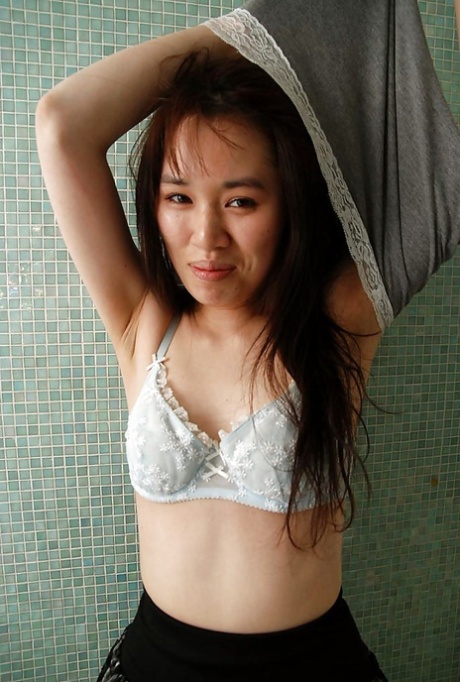 asian teen Kasumi Minasawa undressing and spreading her lower lips in close up