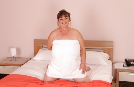 Old plumper with large saggy jugs and hairy cocker on the bed.