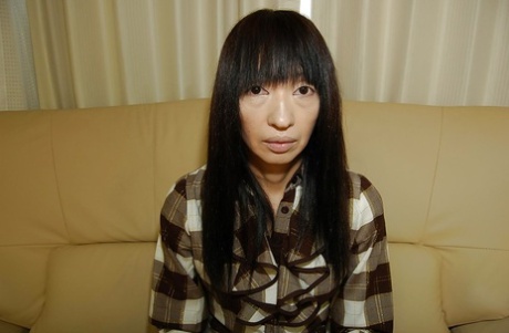 Sweaty asian woman Yoshiko Nagasawa undressing and flaunting her shaggy hair.