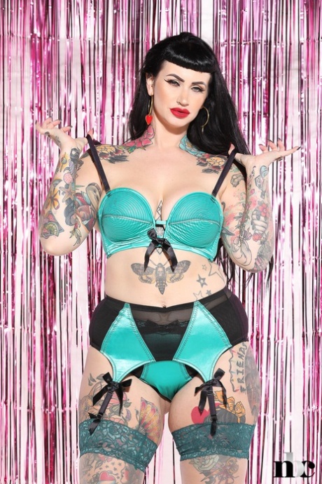 Voluptuous tattooed model Lucy Vixen shows her sexy curves in hot lingerie