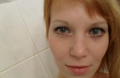 Amateur teen Electra Angel takes a photo of her body while showering herself