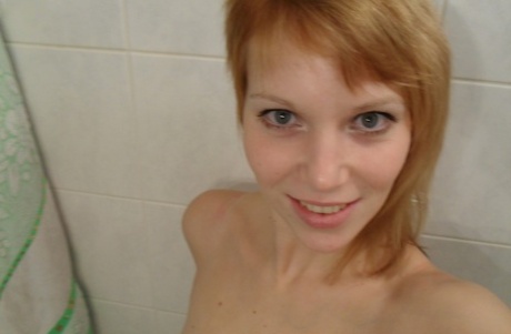 Amateur teen Electra Angel takes a photo of her body while showering herself