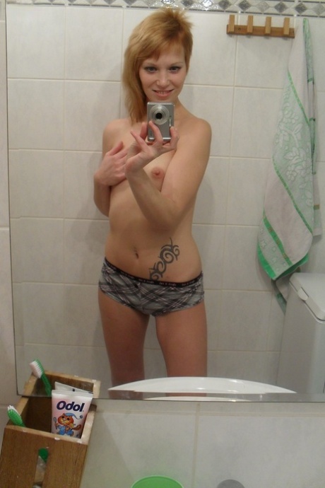 Amateur teen Electra Angel takes a photo of her body while showering herself