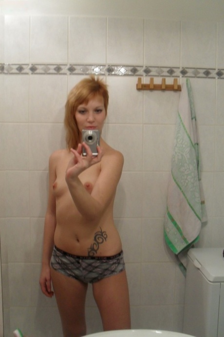In the shower, amateur teen Electra Angel captures a photo of herself while taking a shower.