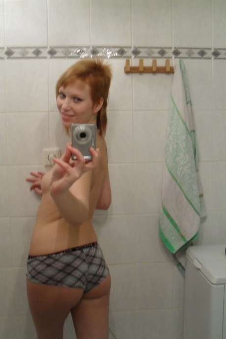 Amateur teen Electra Angel takes a photo of her body while showering herself