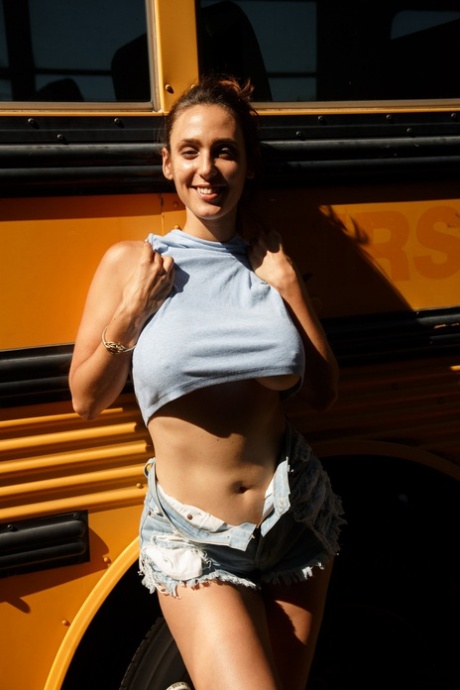 Rhonda Biasi is seen wearing a seductive shirt and shorts while appearing to be unbridled with big tits in a bra.