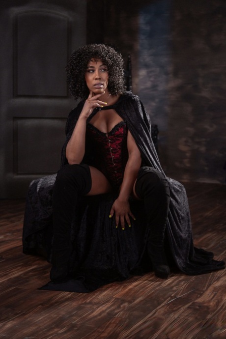 An attractive Halloween costume features Misty Stone, a curly-haired ebony bombshell who exudes sensuality.