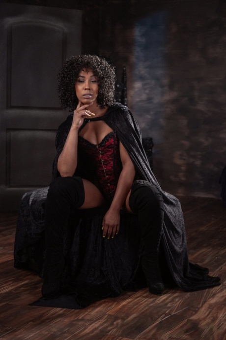 A provocative Halloween costume features Misty Stone, a curly-haired ebony bombshell who exudes sensuality.