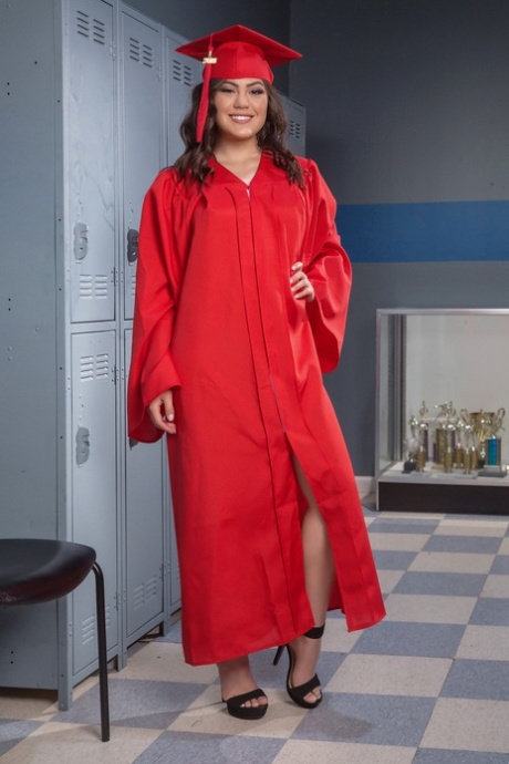 Seductive: Graduation girl Kendra Spade poses nude in a locker room, pulling off her graduation uniform.