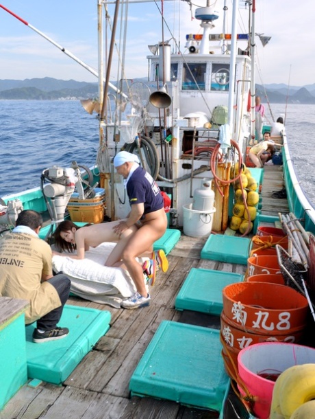 Fun-loving Japanese women enjoying their every trout prickle on the fishing boat.