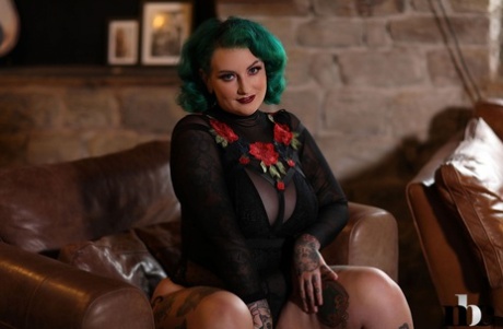 Chubby green haired Galda Lou displays her tattooed body parts.