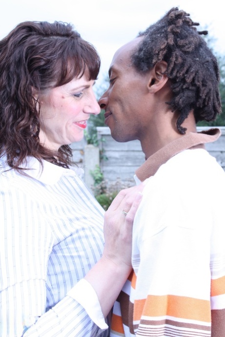 Toni Lace, an adult and horny British woman, kisses a black guy and rides his massive breast.