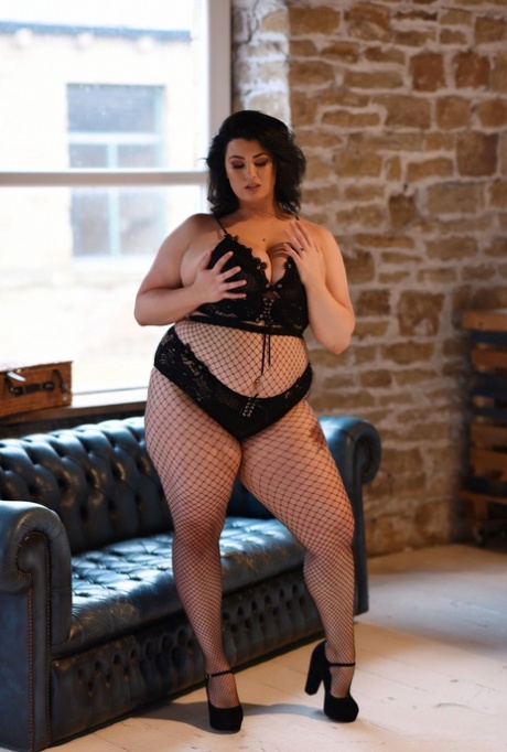 The fat model, Kiki strips her chest and breasts while wearing fishnet tights.