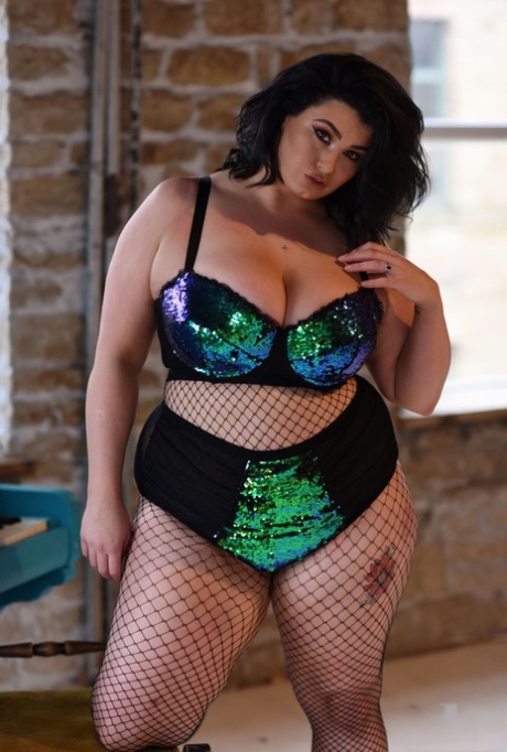BBW Babe Kiki Poses In Fishnets & Strips To Cradle Her Colossal Breasts