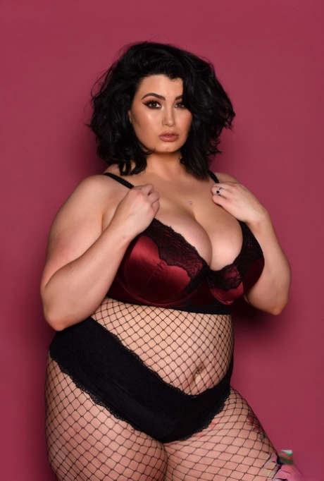 Kiki, who has a full figure, exposes her fat tits while wearing body stockings.