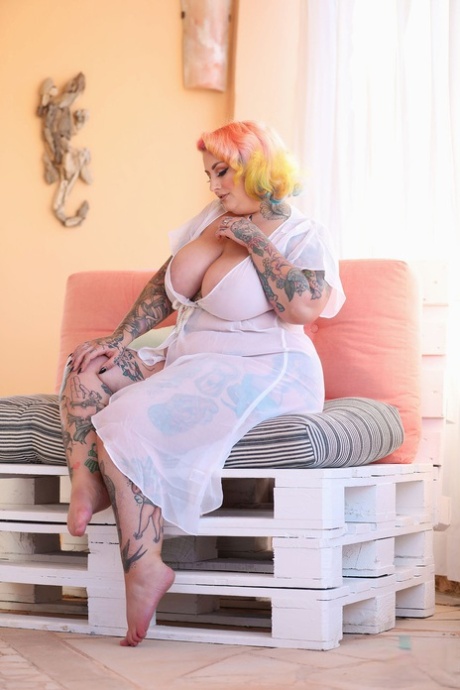 With giant tattoos and rainbow hair, BBW Galda Lou showcases her big tits.