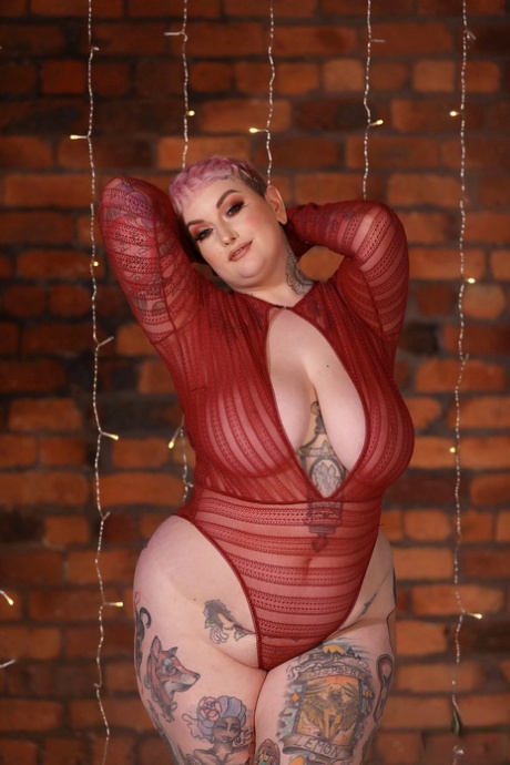 Fatty bloke Galda Lou strips her lingerie and shows off some of the hot, tattooed body parts.