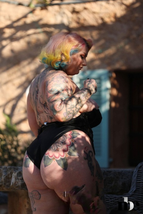 BBW Galda Lou, who has been tattooed, is shown with her huge natural breasts and booty.