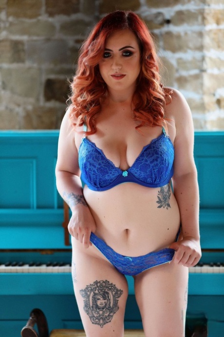 Freyja the redhead-like sextress teases with her big natural curls and round buttocks.