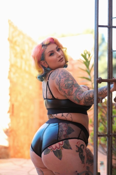 BBW Galda Lou, known for her tattoos, is seen undressing and revealing her large tits and buttocks.