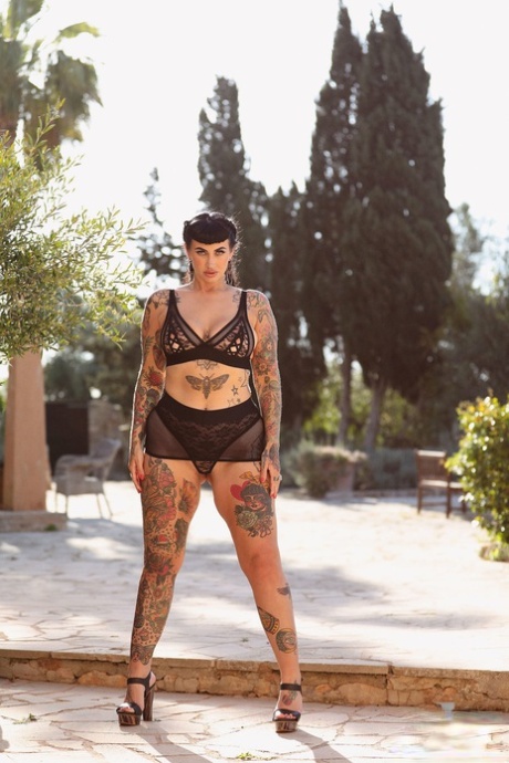 The Chubby Model of the Year, Cherrie Pie poses with her massive ass and large breast area tattooed on her backside.