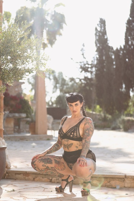 Featuring tattoos, Cherrie Pie models her large buttocks and big thighs.