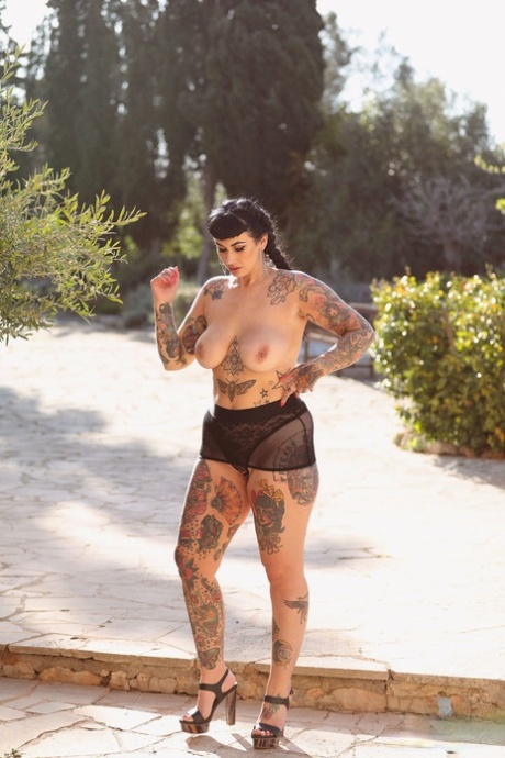 With her tattooed body on display, Cherrie Pie displays a large buttocks and an enormous ass.