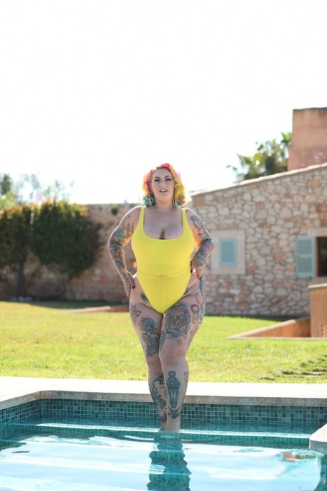 Losing her yellow swimsuit at the pool left Galda Lou, a tall and overweight model with tattoos on her body, looking unhappy.