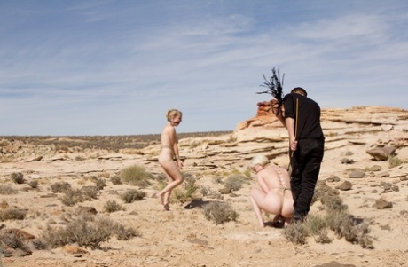 The Desert witnesses Penny Pax and Cherry Torn, two hot blondes known as "Sexy" on the left, being paraded naked and tied up in the middle of the road.