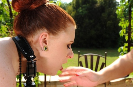 A tattooed woman named Cheryl S. gives a spanking and toy bath outside with her kitty, Isabel Dean (pictured).