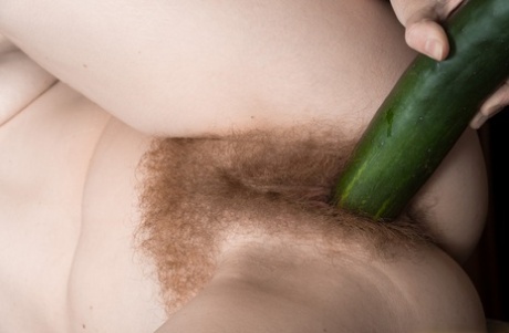 An aroused Ana Molly, a flirty maid of her own nature, inserts an enormous cucumber into the side of her thick vagina and proceeds to suck it.