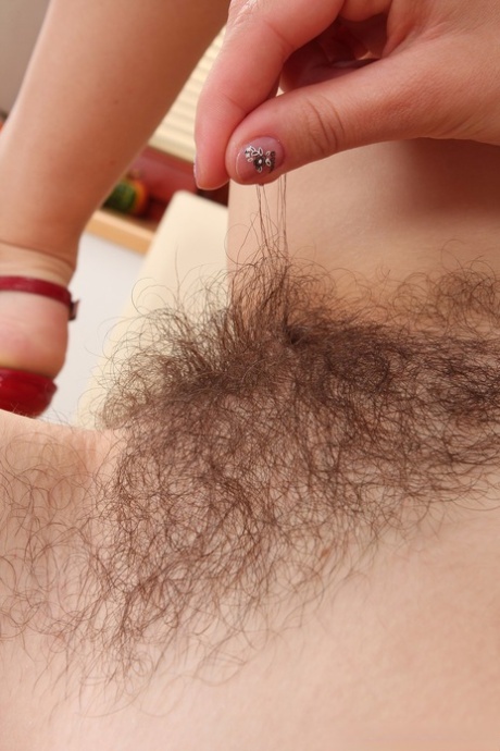 Nessy, the adorable amateur, exposes her hairy pussy and ruffles it up close.