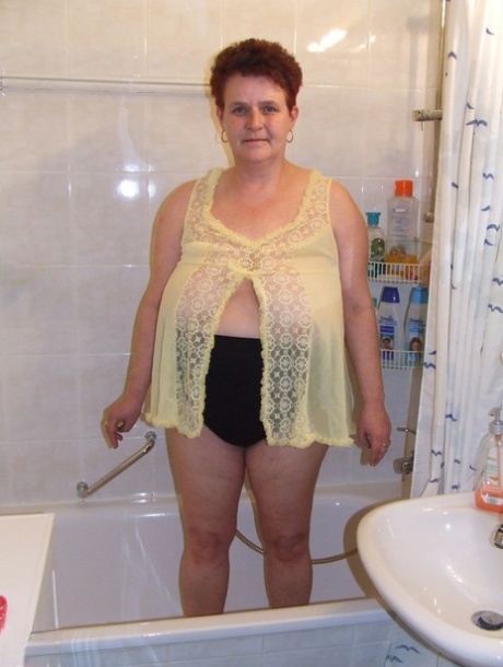 Chubby woman Ingeborg, who is a housewife, plays with her saggy breasts in the bathroom.