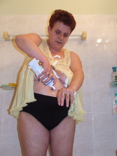 While in the bathroom, Ingeborg (the shabby housewife) plays with her loose breasts.