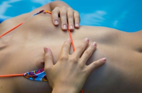 Teen amateur Lolly teasing in a bikini and showing her tiny tits by the pool