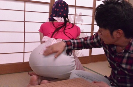 The erotic Japanese housewife, Nanami Hirose, exhales while experiencing intense sexual stimulation.