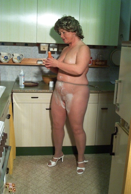 Little granny Rita takes off her dress and nylons in the kitchen area.