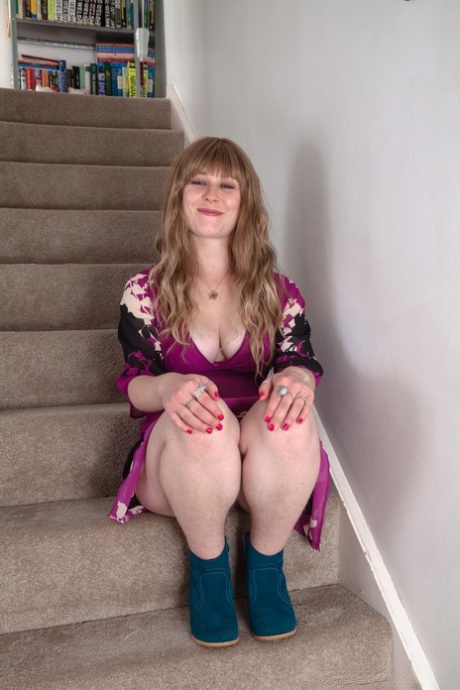 A doll with tattoos, Betty Busen reveals her juicy tits and hairless crotch on the stairs.