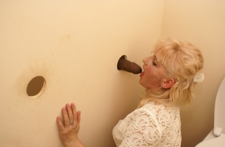 Blonde Granny MaireAnn Gets Blacked Through A Gloryhole And Enjoys A Facial